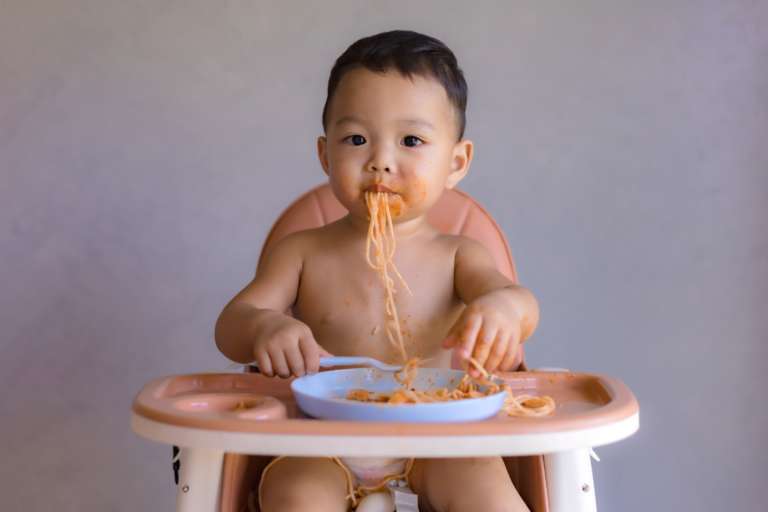 Toddler eating spaghetti